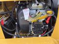 Close-up of the engine compartment of a 2024 AGT Industrial KRW23 Mini Loader showcasing various wires components and a yellow switch