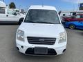 A white 2013 Ford Transit Connect van with a prominent front grille and headlights, featuring a plain license plate area
