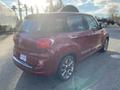 A red 2015 Fiat 500L parked with a rounded rear design and distinctive taillights showcasing its compact SUV shape