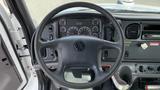 Interior view of a 2010 Freightliner M2 106 dashboard showing the steering wheel and instrument panel with gauges and controls