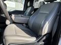 A gray leather seat of a 2018 Ford F-550 with a center console in view