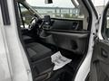 Interior view of a 2021 Ford Transit showing the driver's seat dashboard and console with a touchscreen display and a floor mat that says Thank You