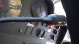 A close-up view of the control panel of a 2011 Ford Econoline showing the gear shift and various buttons including a seatbelt indicator and other controls