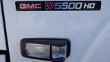 GMC W5500-HD emblem featuring the model name and a vehicle headlight with a clear lens