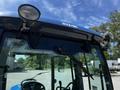 A blue 2018 New Holland Boomer 45 tractor with a prominent BOOMER logo on the roof and mounted lights attached to the front