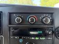 Dashboard controls of a 2019 Chevrolet Express featuring knobs for temperature and fan speed along with a digital display showing the time 220