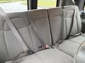 Interior view of the back seat of a 2021 Chevrolet Express with gray fabric upholstery and seat belts attached