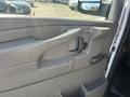 Interior door panel of a 2013 Chevrolet Express featuring a door handle and control for window operation