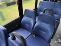 Interior seats of a 2020 Chevrolet Express featuring blue padded upholstery and seatbelts