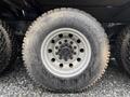 Close-up of a muddy tire on a 2018 Kenworth T800 showcasing a metallic rim and deep treads designed for rugged terrain