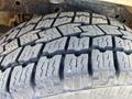 Close-up of a tire tread on a 2014 Ford F-150 showcasing deep grooves and rugged texture designed for traction and durability
