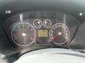 Dashboard of a 2010 Ford Transit Connect displaying speedometer fuel gauge and warning lights with an odometer reading of 124706 miles