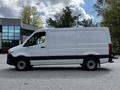 A white 2020 Mercedes-Benz Sprinter van viewed from the side with a high roof and sliding door on the passenger side