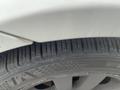 Close-up of a tire from a 2011 BMW 3-Series showing tread pattern and sidewall details