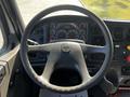 Steering wheel and dashboard of a 2004 Freightliner M2 showing gauges and controls
