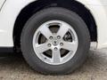 Close-up of a silver alloy wheel with a distinctive design mounted on a tire labeled Nokian 225/65R16 for a 2011 Dodge Grand Caravan