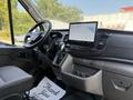 Interior of a 2022 Ford Transit with a steering wheel and a large touchscreen display on the dashboard