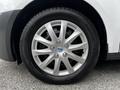 Close-up of a 2014 Ford Transit Connect wheel featuring a silver alloy rim with five spokes and a black tire