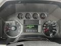 Dashboard of a 2008 Ford F-450 SD showing gauges for RPM speed and engine hours with indicators for transmission gear and speed in kilometers per hour