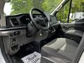Interior of a 2022 Ford Transit with a steering wheel a driver seat and dashboard displaying gauges and controls