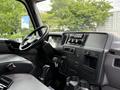 Interior dashboard of a 2022 International MV607 featuring controls a steering wheel and an array of buttons and displays