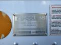 A metal identification plate displays manufacturing information for a 2014 Hino 195 truck with details including a model number and contact information