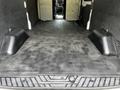 The interior of a 2022 Ford Transit van showing a spacious cargo area with a flat rubberized floor and raised sidewalls
