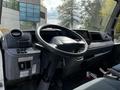 Interior of a 2015 Mitsubishi Fuso FE truck featuring a steering wheel dashboard and control panel