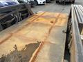 A 2013 JLG Industries 1014 with a textured metal platform showing signs of wear and rust