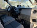 Interior view of a 2009 Ford F-550 showing the dashboard with controls and seating area