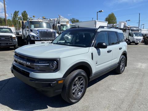 A 2023 Ford Bronco Sport in a light green color with a black roof and wheels parked in a lot