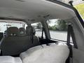Interior view of a 2003 Mitsubishi 7 Passenger Van showing the back seats and seatbelt configuration
