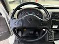 A 2011 International 4300 dashboard showing a steering wheel with buttons and a cluster of gauges behind it along with a control panel on the right
