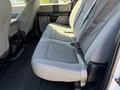 A 2017 Ford F-350 SD with gray fabric interior seating in the back row showcasing three passenger seats and seatbelt straps