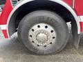 A close-up view of a tire from a 2006 E-One Typhoon fire truck featuring a multi-bolt wheel hub and a rugged tread pattern