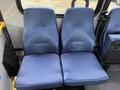 Two blue upholstered seats from a 2017 Chevrolet Express van are positioned next to each other with a textured surface and a streamlined design