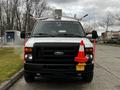 A 2011 Ford Econoline van with a white body displaying a traffic cone mounted on the front and additional signage equipment on top