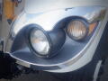 Close-up of the front headlight assembly of a 2016 International WorkStar 7500 featuring a chrome bezel and circular headlights