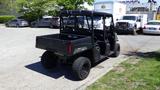 A black 2016 Polaris Ranger 570 Crew all-terrain vehicle with a cargo bed and four seats visible from the rear angle