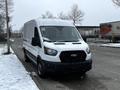 A 2021 Ford Transit van in white with a black front grille parked on a snowy street