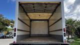 A 2016 Isuzu NPR cargo truck with an empty interior showing wooden slats and a clean floor