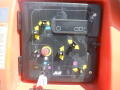 Control panel of a 2008 JLG Boom Lift featuring buttons and joystick levers for operation with directional indicators and a key slot