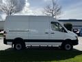 A 2017 Mercedes-Benz Sprinter van in white with a high roof and sliding side door visible from the profile angle