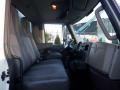 The interior of a 2014 International Durastar truck featuring two gray seats and a dashboard with controls and steering wheel