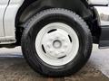 A close-up view of a wheel from a 2022 Ford E-450 featuring a white rim and a Hankook Dynapro H/T tire