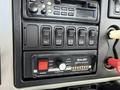 Dashboard panel of a 2008 International 7500 featuring various control switches including a Whelen traffic advisor and power function buttons