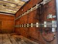 A 2007 GMC W3500 truck with an empty wooden cargo area featuring exposed walls and electrical outlets
