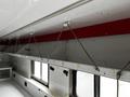 Interior of a 2013 Ford Econoline with overhead shelving and support ropes visible