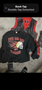 A black sweatshirt with "THE BIG RED MACHINE" and a skull design alongside a red and black vest