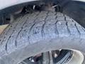 Close-up of a heavily worn tire from a 2017 RAM 1500 featuring a rugged tread design showing significant signs of use and wear